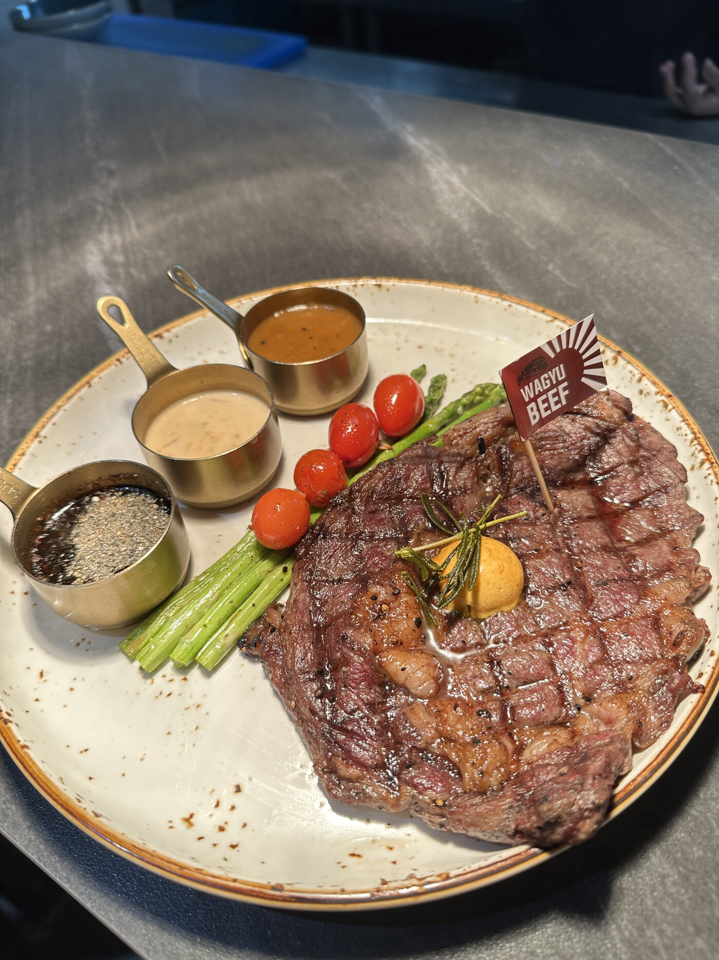 AUS Wagyu Rib Eye MB4/5, char-rock grilled with trio of sauces